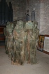 Wood carving of monks carrying St. Cuthbert's casket.